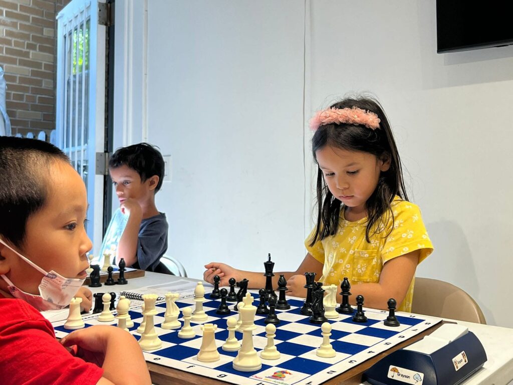 Children playing chess at Chess Max Academy East 78th
