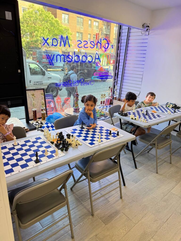Child practicing chess in a class at the Lexington Avenue academy