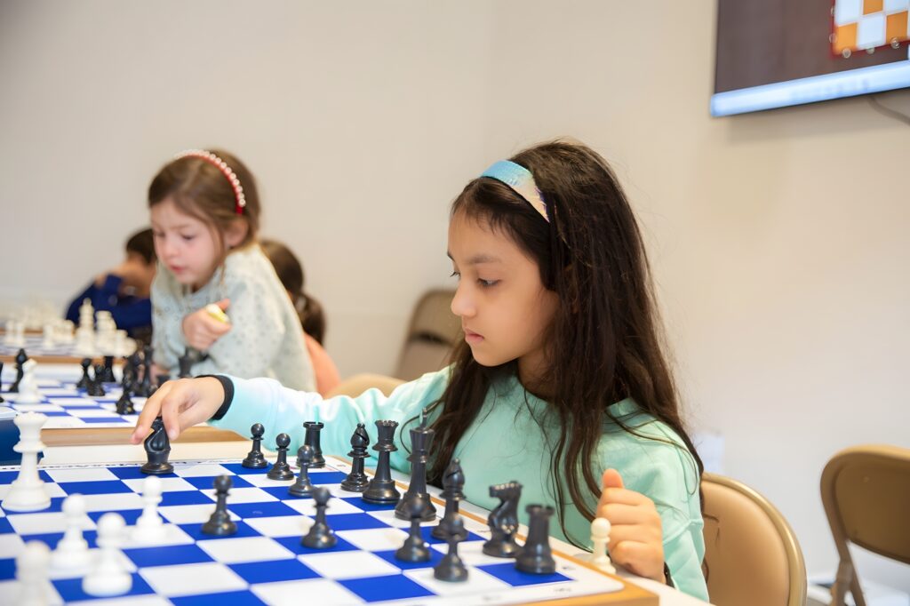 Student concentrating on a chess position at Chess Max Academy Lex 93rd