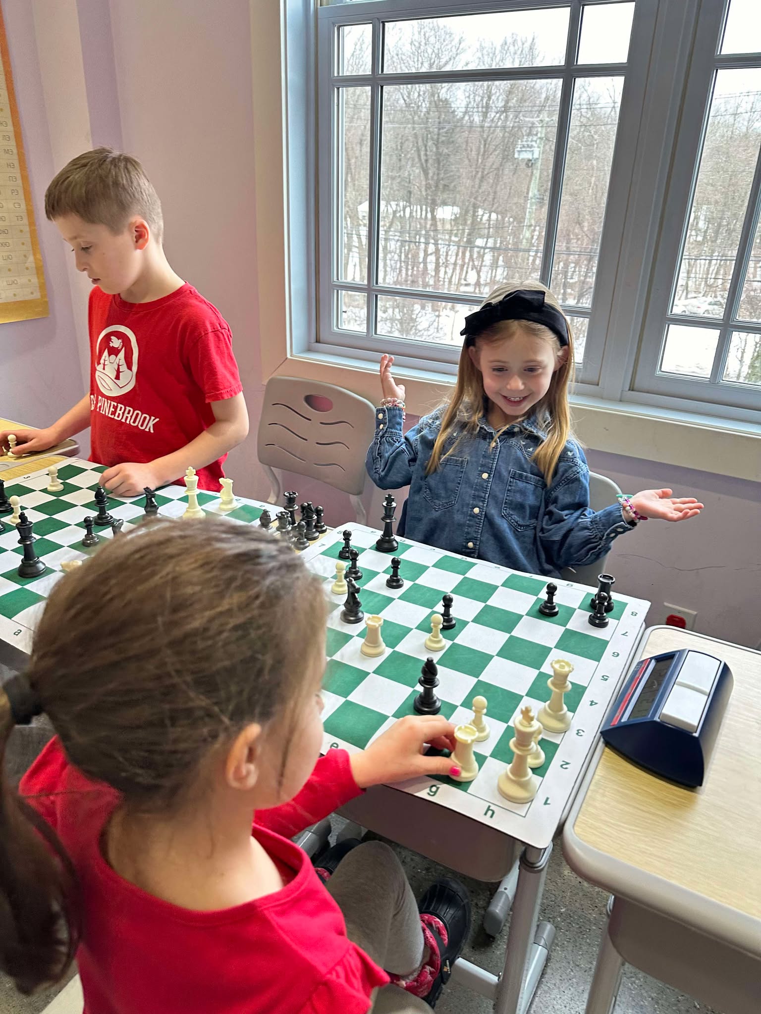 Young chess student analyzing a position during a tournament