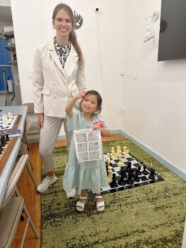 Student with completed chess work at Chess Max Academy Upper East Side