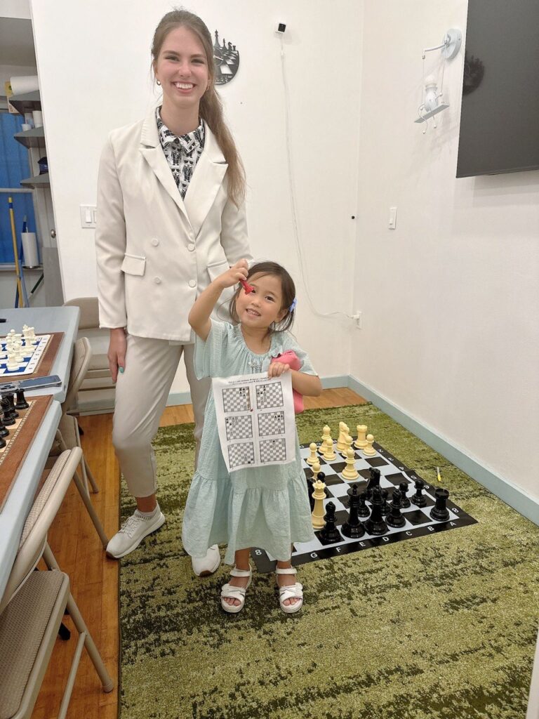 Student celebrating completed chess work at Chess Max Academy Upper East Side