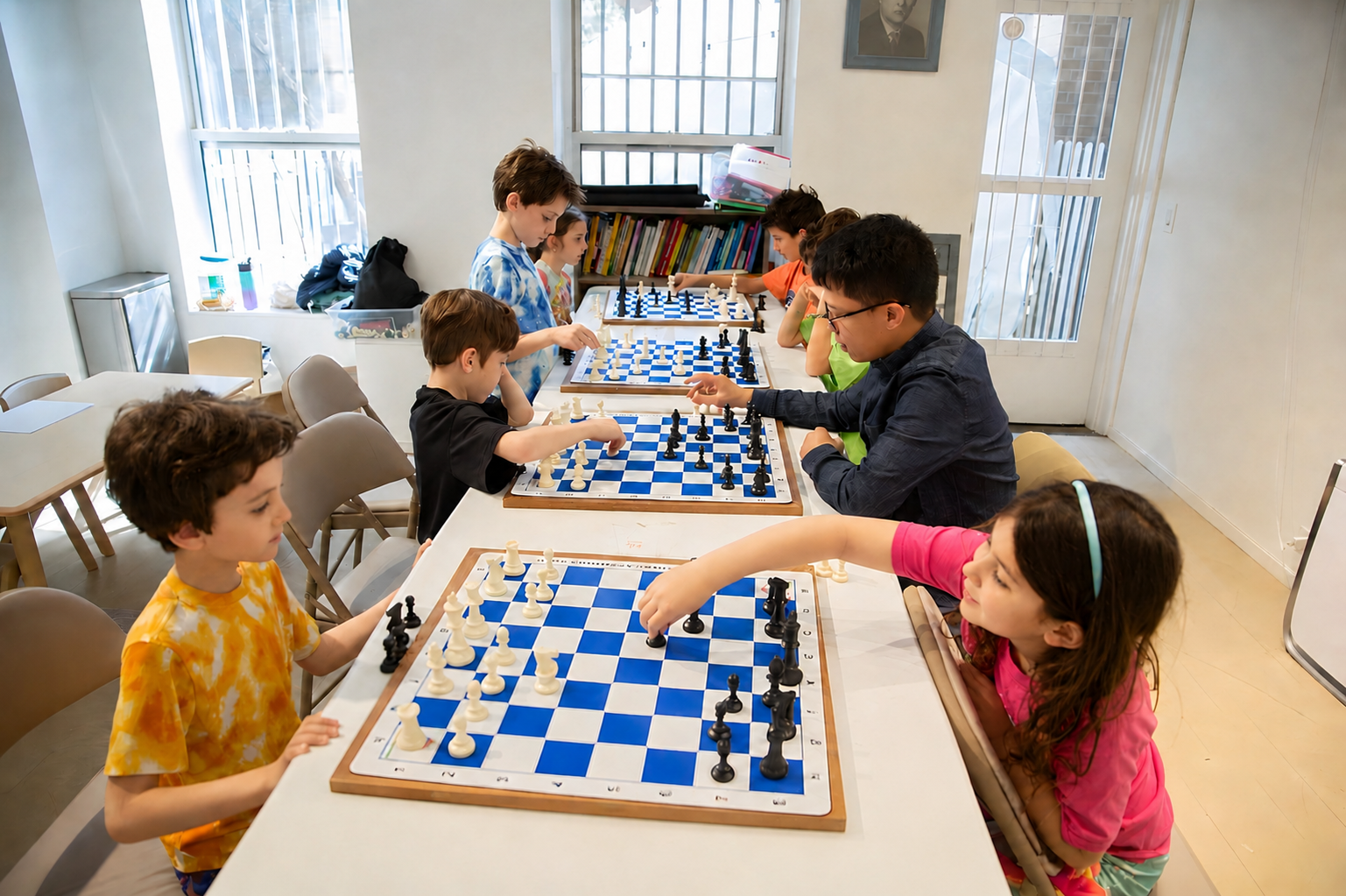 Kids learning chess with a coach at Chess Max Academy