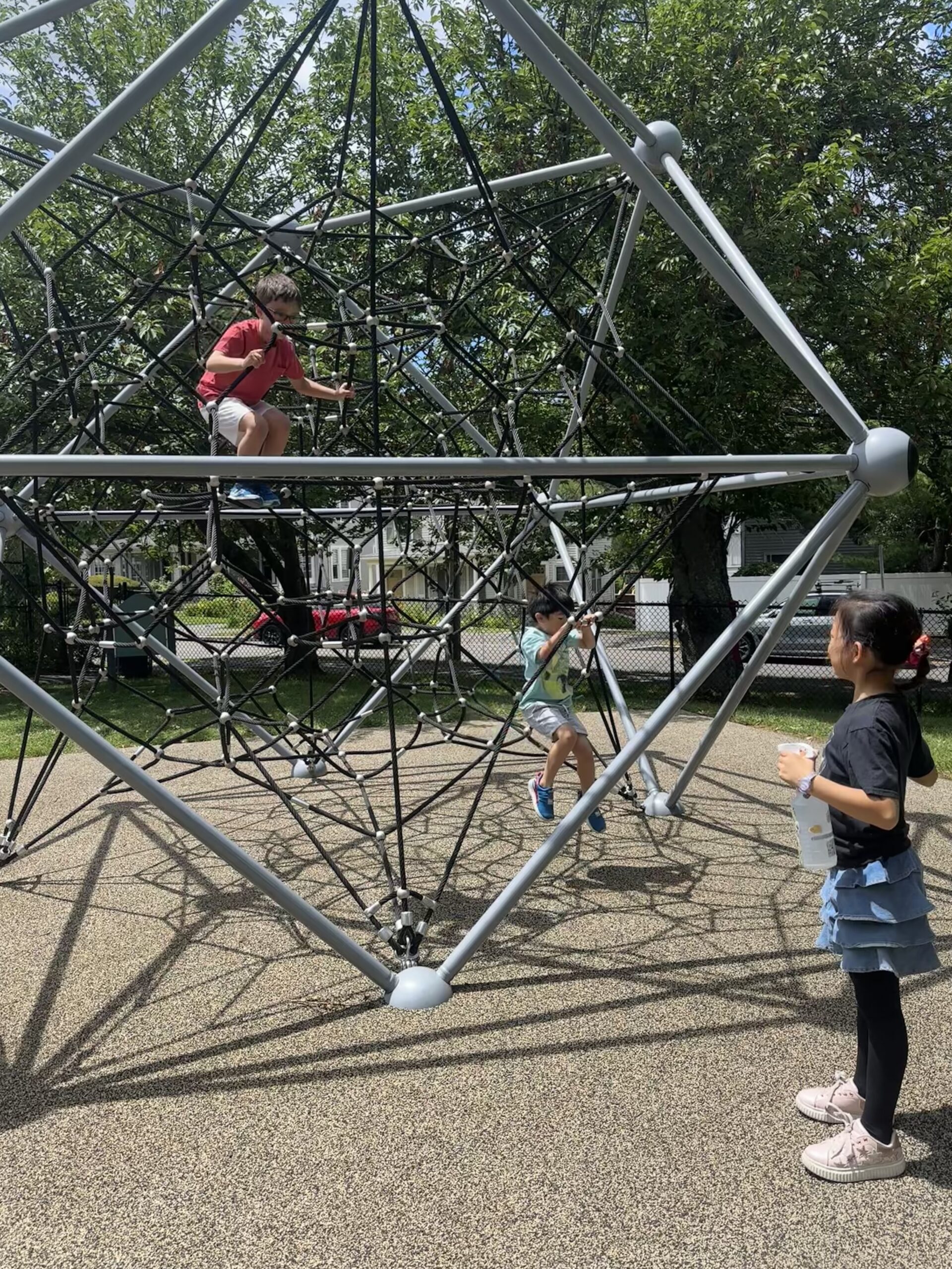 Children climbing outside during summer camp break time
