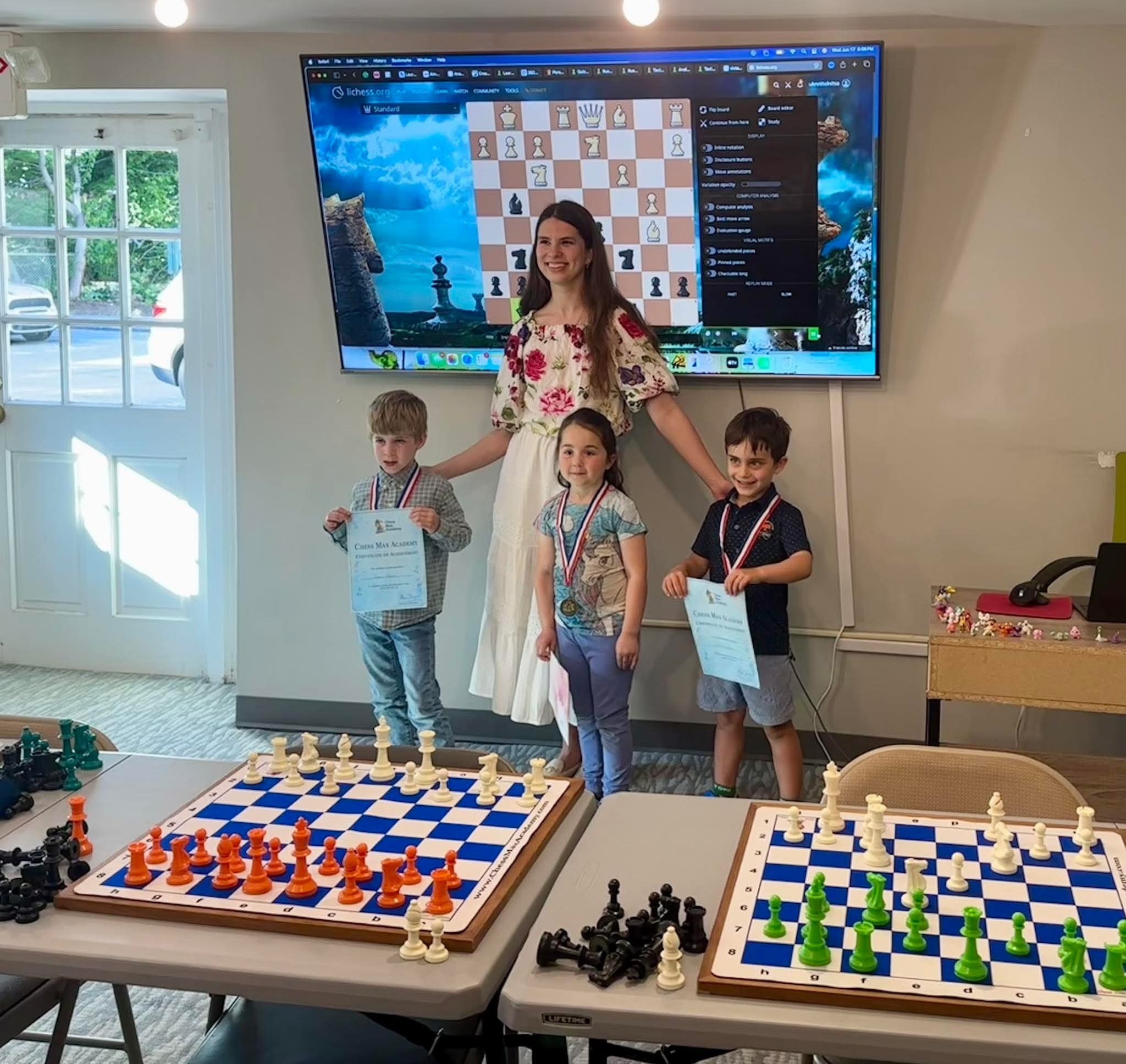 Campers smiling with certificates during Chess Max summer camp