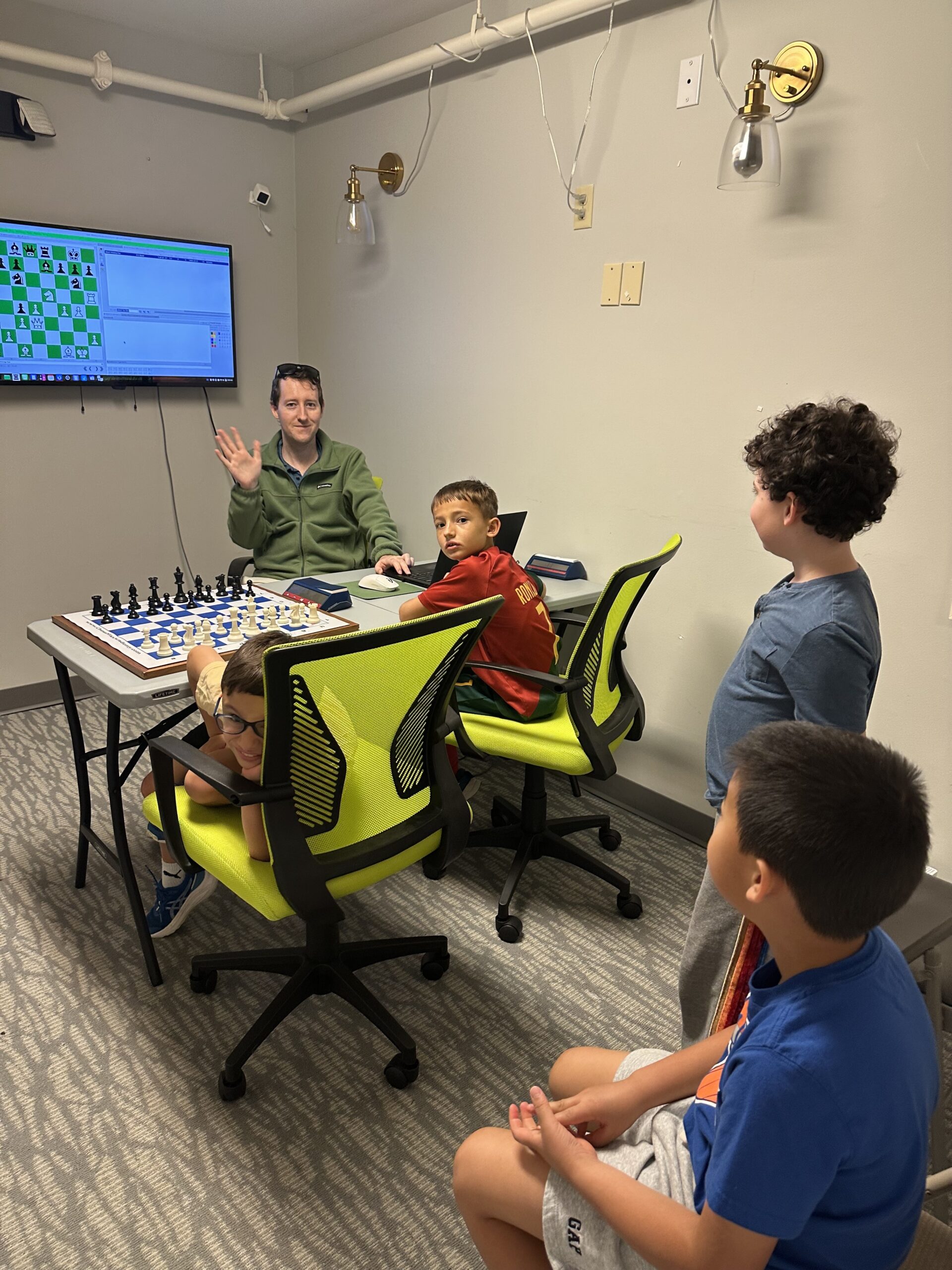 Campers analyzing a chess position during a focused lesson
