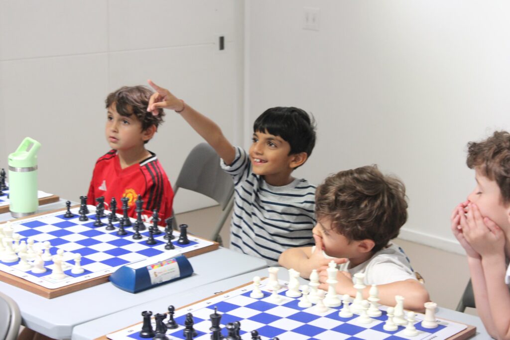 A Chess Max Academy student answering a coach's question during a lesson