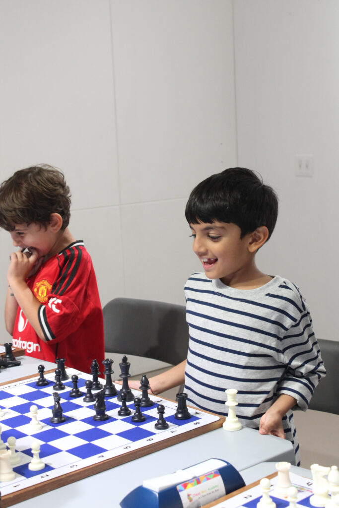 Two students reacting to a chess position at Chess Max Academy