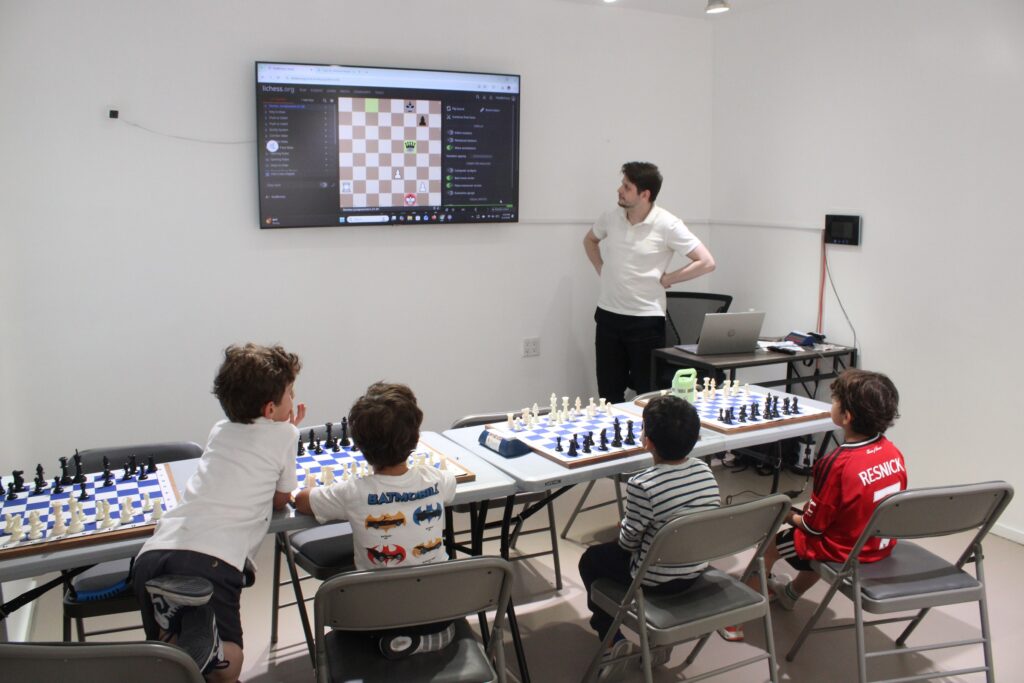 Coach leading an Upper West Side group chess lesson at Chess Max Academy