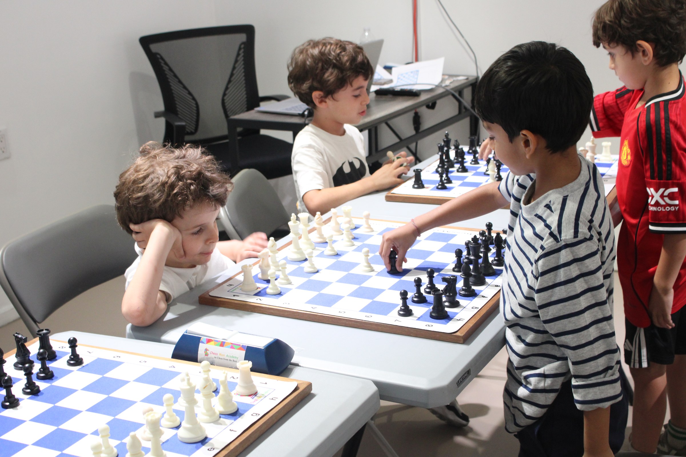 Upper West Side students analyzing a chess game together