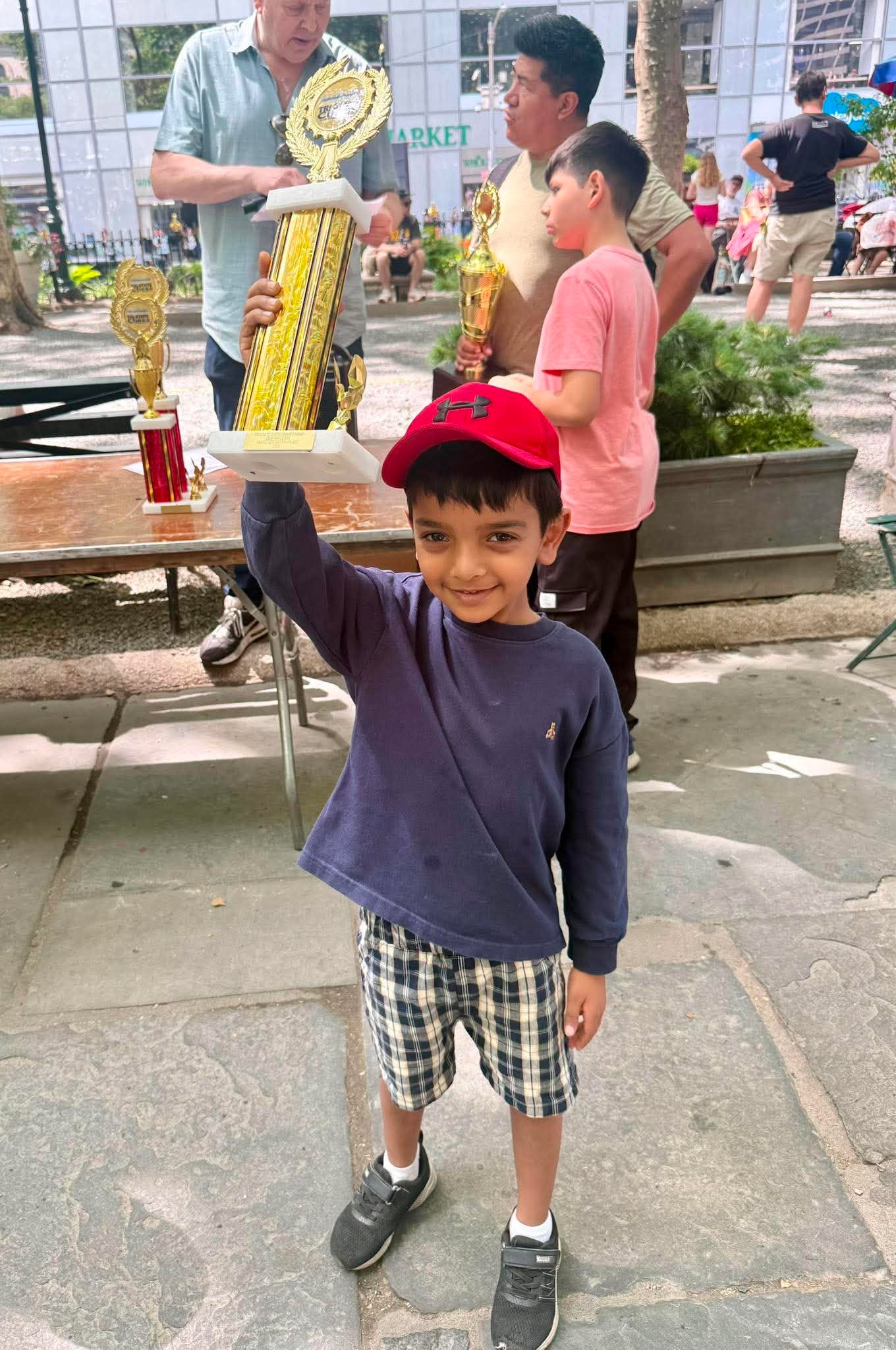 Ayaan Malladi with a chess trophy