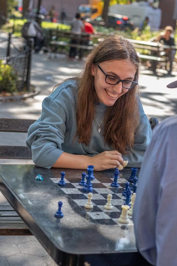 Maddie Weber playing chess outdoors
