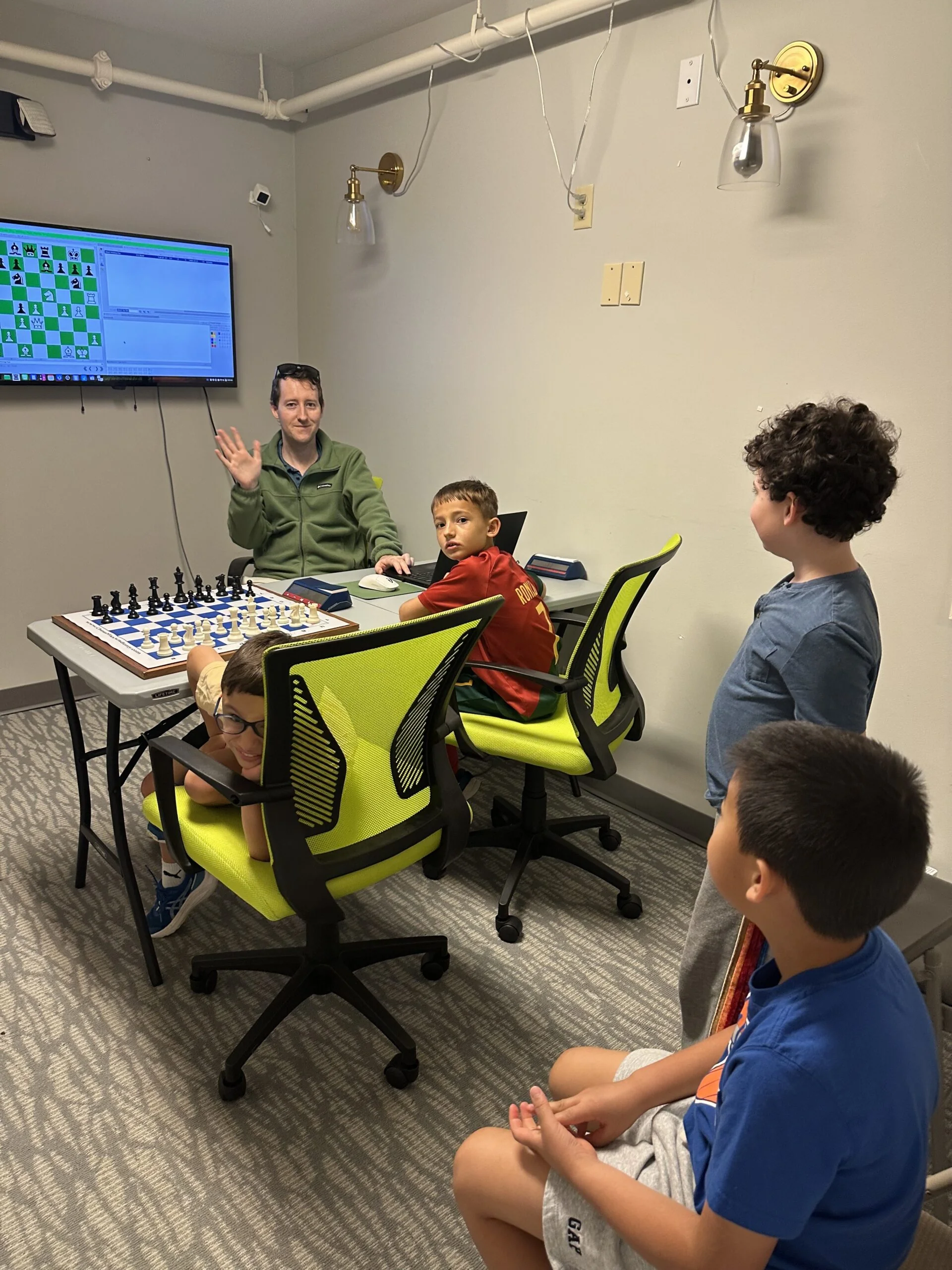 Campers analyzing a chess position during a focused lesson