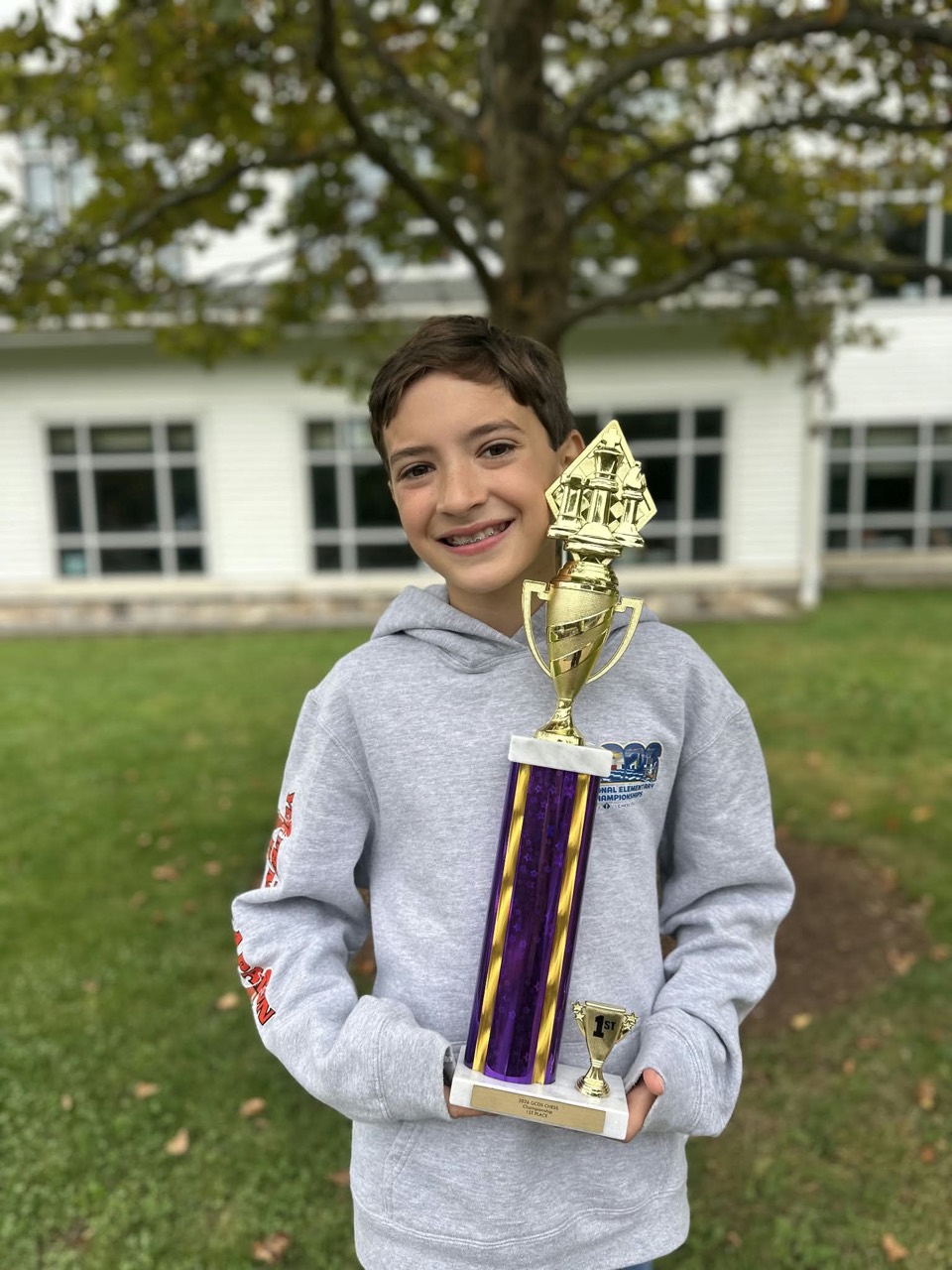 Taj Ahluwalia holding his first-place chess trophy